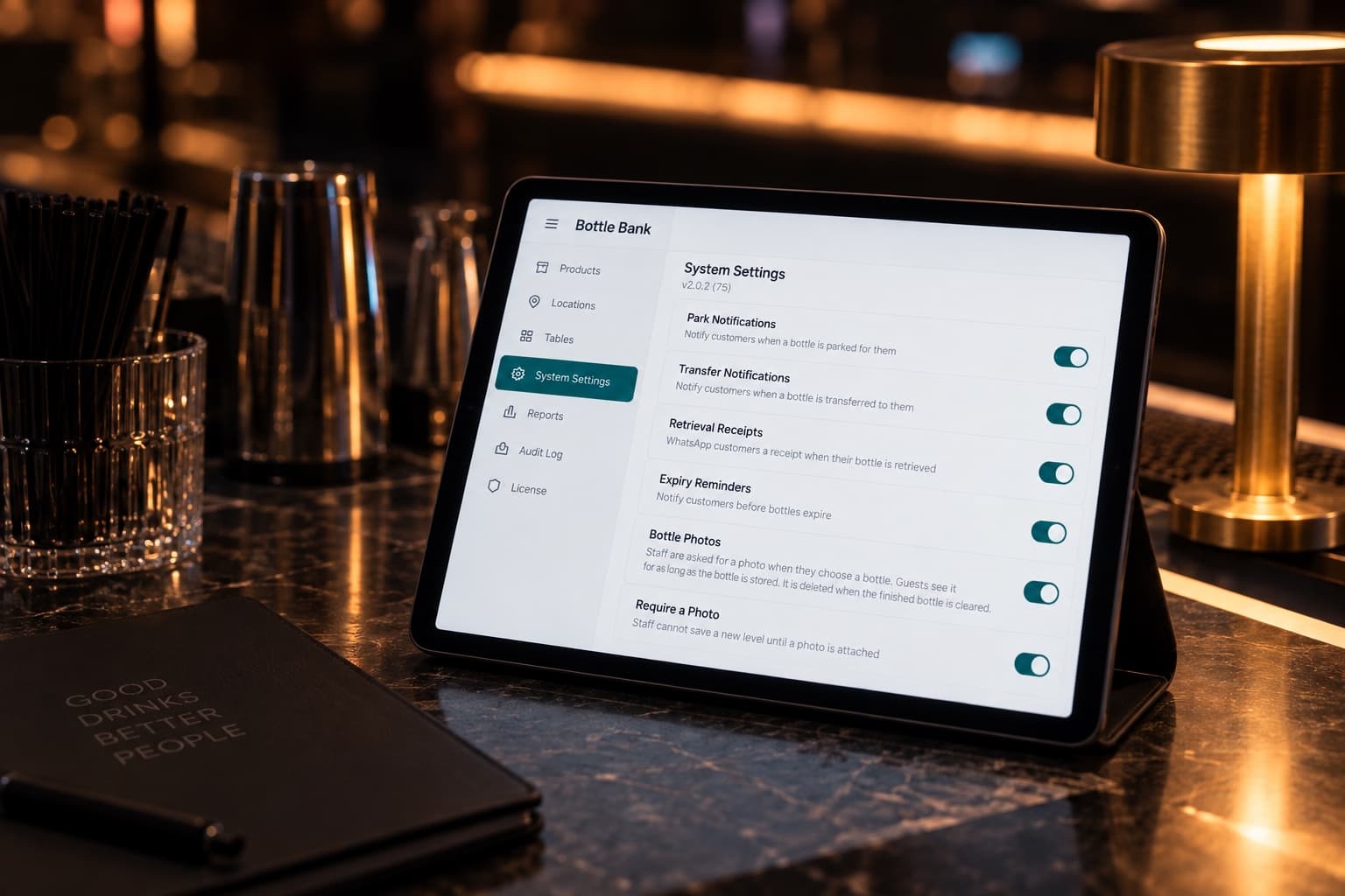 An iPad on a bar showing System Settings with six house rules as switches, all on: Park Notifications, Transfer Notifications, Retrieval Receipts, Expiry Reminders, Bottle Photos, Require a Photo